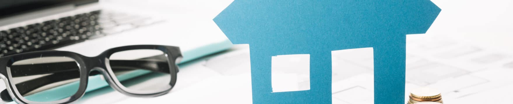 small-house-figurine-coins-laptop